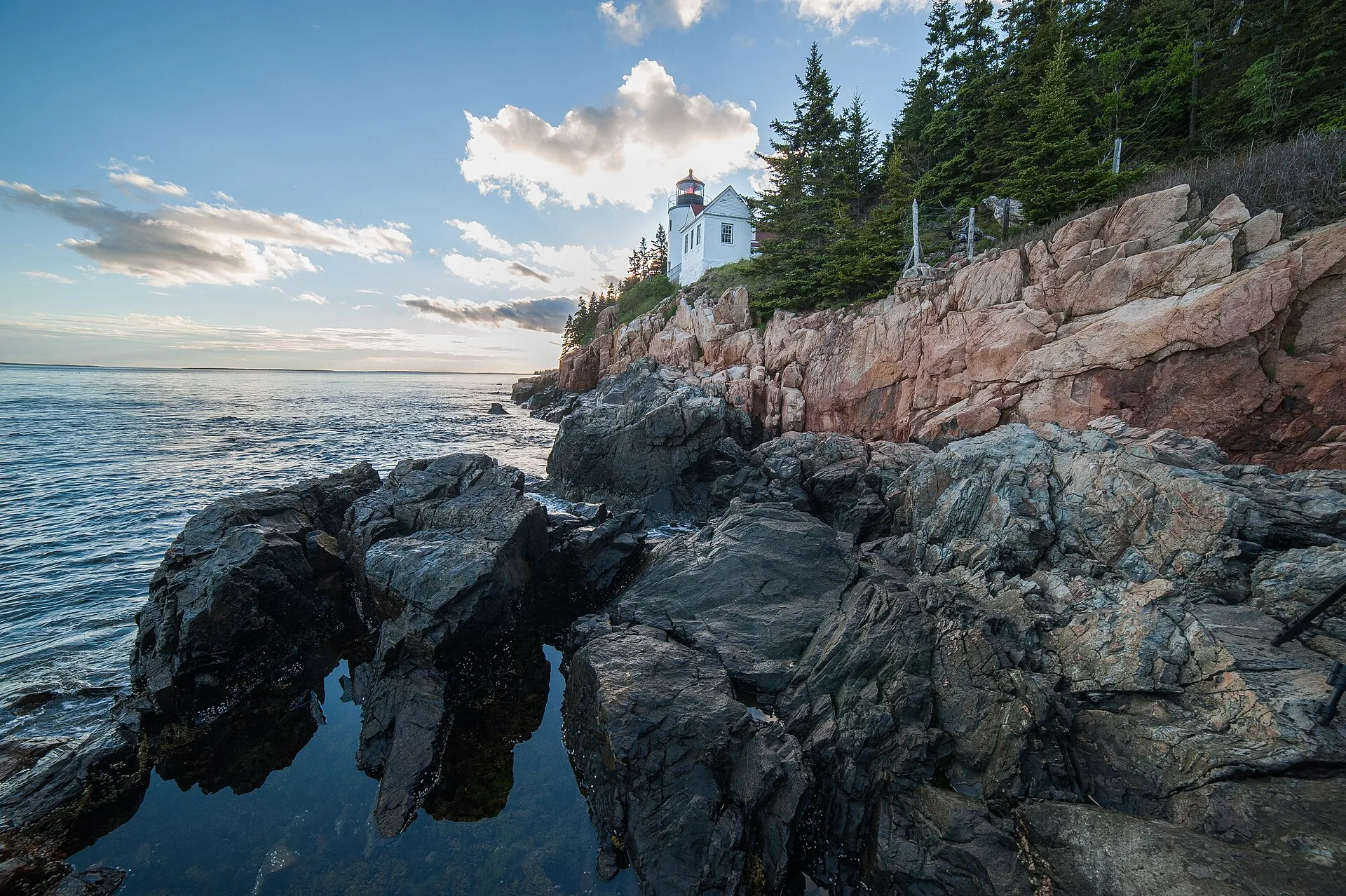 The classic view of Bass Harbor Head Light, looking up from the boulders below the cliff at the southwestern tip of Mount Desert Island.