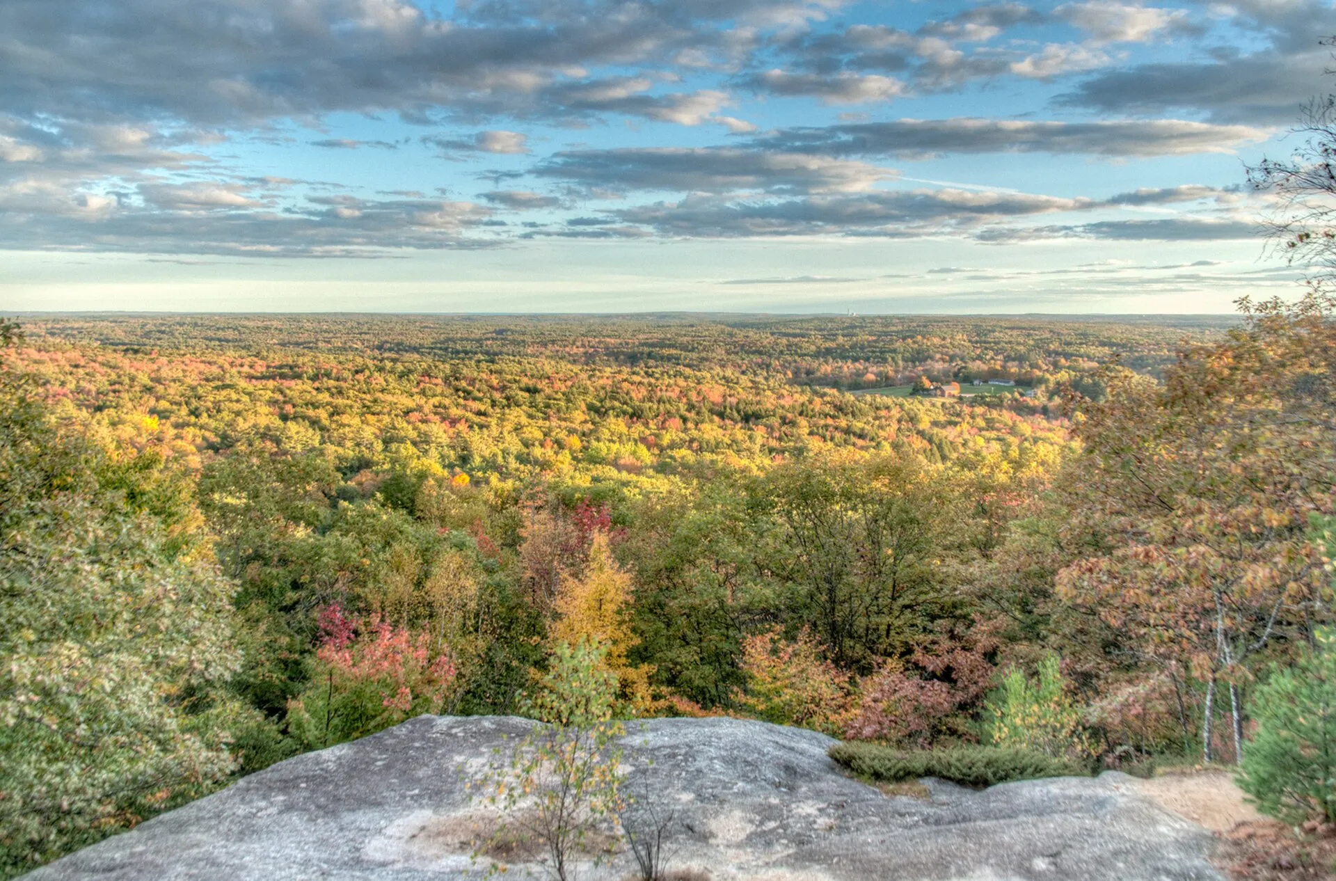 The view west from Bradbury Mountain's summit ledges in Pownal, late on an autumn afternoon. The climb from the car park is only about 300 feet, which is why the horizon sits low and wide.