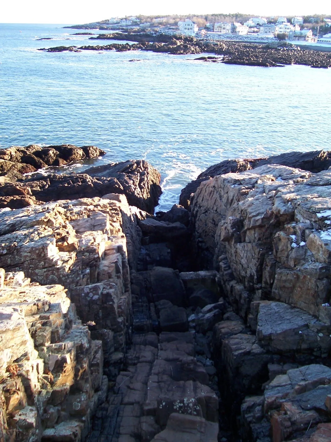 A deep rock flume cut into the ledge below the Marginal Way at Oarweed Cove, Ogunquit
